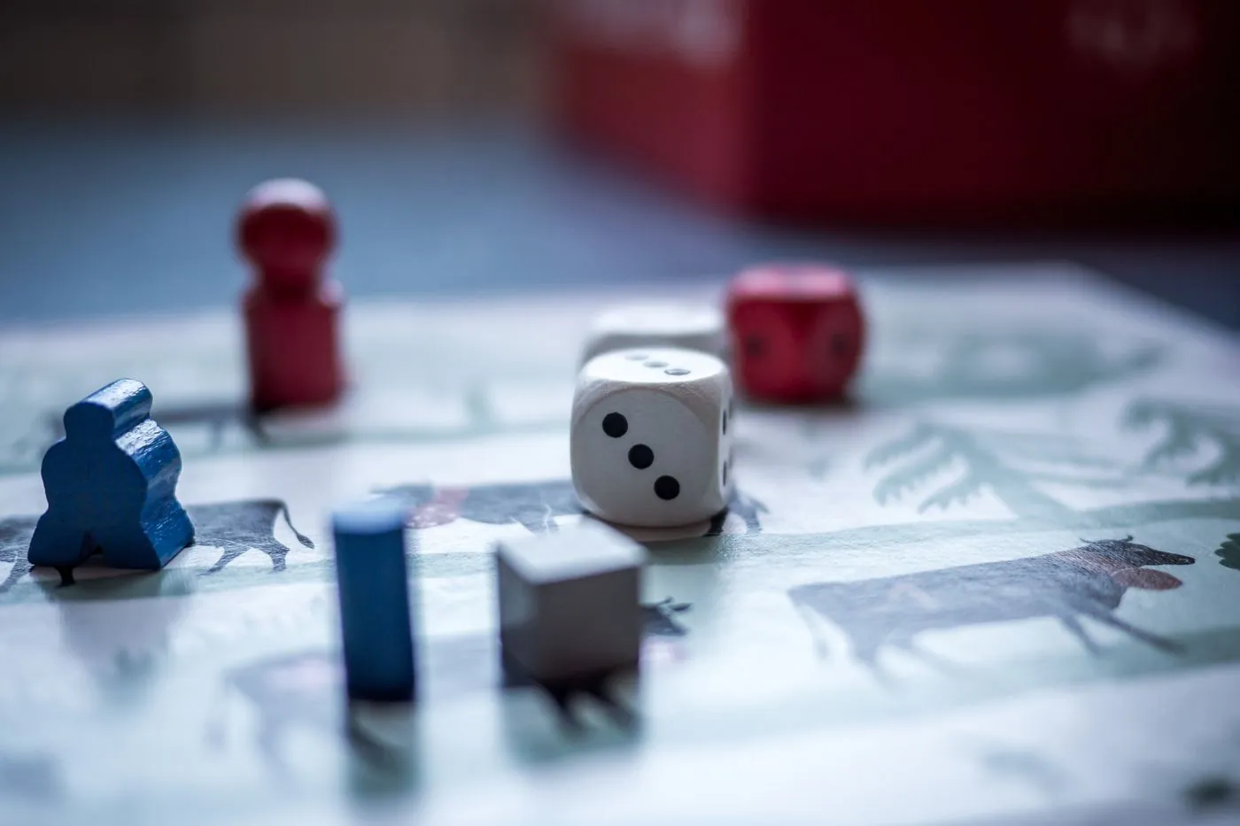 Primo piano di pedine in legno e dadi su un tabellone di un gioco di strategia